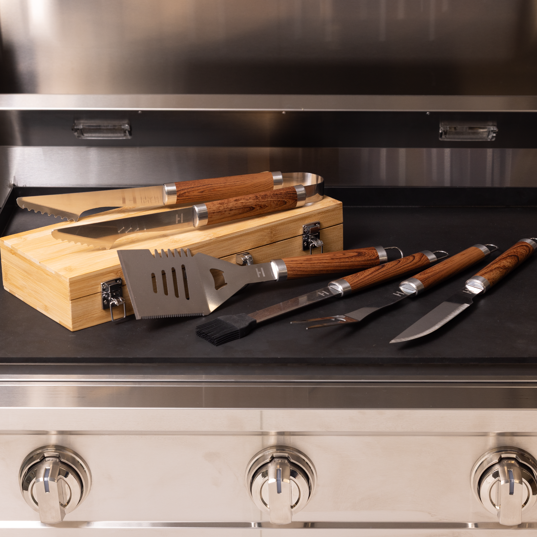 Barbecue tools with wooden handles on a grill