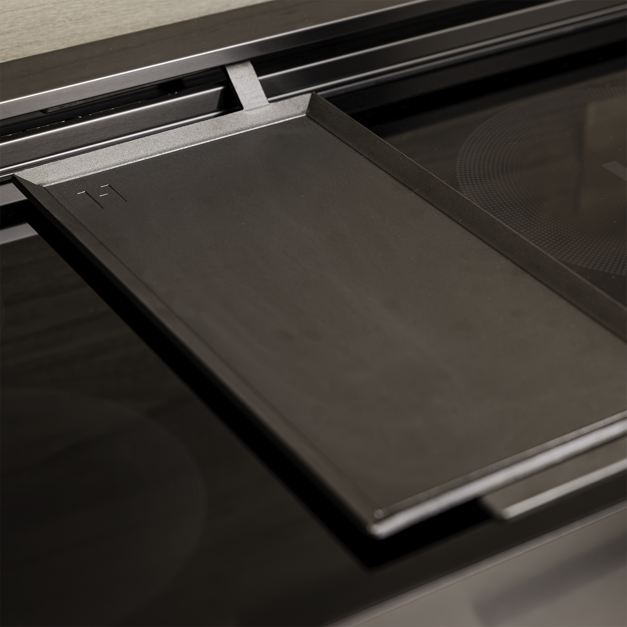 Carbon Steel Griddle Plate seated across two induction burners on an Induction Hardware range